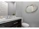 Modern bathroom with dark vanity and a sleek, frameless mirror at 10157 E Texas Ave, Mesa, AZ 85212