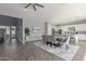 Open dining area with gray chairs and a view of the kitchen and entryway at 10157 E Texas Ave, Mesa, AZ 85212