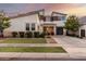 Two-story home with modern design, attached garage, and landscaped lawn at 10157 E Texas Ave, Mesa, AZ 85212
