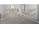 Upstairs hallway with gray carpet and modern railing at 10157 E Texas Ave, Mesa, AZ 85212