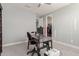 Bright home office features a desk, chair, and built-in shelving at 10157 E Texas Ave, Mesa, AZ 85212