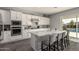 Open concept kitchen with white cabinets and quartz countertops at 10157 E Texas Ave, Mesa, AZ 85212