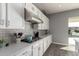White kitchen with subway tile backsplash and stainless steel appliances at 10157 E Texas Ave, Mesa, AZ 85212