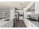 Modern kitchen with white cabinets, stainless steel appliances, and quartz countertops at 10157 E Texas Ave, Mesa, AZ 85212