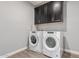 Laundry room with washer, dryer, and upper cabinets at 10157 E Texas Ave, Mesa, AZ 85212