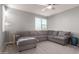 Spacious living room with gray sectional sofa and ceiling fan at 10157 E Texas Ave, Mesa, AZ 85212