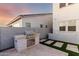 Built-in outdoor kitchen with stone accents and modern appliances at 10157 E Texas Ave, Mesa, AZ 85212