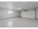 Spacious, well-lit garage with a white garage door and ample storage at 11402 N Arbor Ct, Sun City, AZ 85351