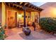 Inviting entryway with terracotta tile flooring, wooden door, and a pergola at 15155 E Westridge Dr, Fountain Hills, AZ 85268