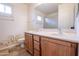 Double sink bathroom with wood cabinets and shower at 16068 W Edgemont Ave, Goodyear, AZ 85395