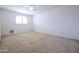 Simple bedroom with neutral walls and carpet at 16068 W Edgemont Ave, Goodyear, AZ 85395