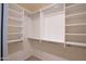 Large walk-in closet with custom shelving and hanging rods at 16068 W Edgemont Ave, Goodyear, AZ 85395