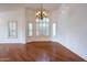 Formal dining room with hardwood floors, large window, and chandelier at 16068 W Edgemont Ave, Goodyear, AZ 85395