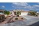 Two-story house with desert landscaping, two-car garage, and solar panels at 16068 W Edgemont Ave, Goodyear, AZ 85395