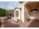 Front entry with double doors, brick patio, and arched entryway at 16068 W Edgemont Ave, Goodyear, AZ 85395