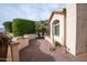 Brick patio with desert landscaping and a curved stucco wall at 16068 W Edgemont Ave, Goodyear, AZ 85395