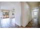 A well-lit hallway with tile flooring, leading to other rooms at 16068 W Edgemont Ave, Goodyear, AZ 85395