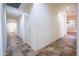 Long hallway with tile flooring and access to other rooms at 16068 W Edgemont Ave, Goodyear, AZ 85395