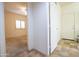Hallway with tile floors and doors to bedrooms and other areas at 16068 W Edgemont Ave, Goodyear, AZ 85395