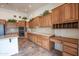 Kitchen with wood cabinets, island, and tile flooring at 16068 W Edgemont Ave, Goodyear, AZ 85395