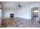 Open living room with tile floors and fireplace at 16068 W Edgemont Ave, Goodyear, AZ 85395