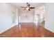 Bright living room with hardwood floors, high ceilings, and a ceiling fan at 16068 W Edgemont Ave, Goodyear, AZ 85395