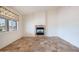 Living room featuring a fireplace and large window at 16068 W Edgemont Ave, Goodyear, AZ 85395