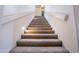 Carpeted staircase with wall-mounted lights at 16068 W Edgemont Ave, Goodyear, AZ 85395