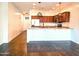 Modern kitchen with a breakfast bar, stainless steel appliances, and wood-look flooring at 1627 S 104Th Ln, Tolleson, AZ 85353