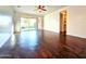 Spacious living room with wood-look flooring and sliding glass doors to the backyard at 1627 S 104Th Ln, Tolleson, AZ 85353