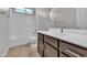 Bathroom with white tile shower/tub, dark wood vanity, and modern fixtures at 2517 N Pony Ln, Casa Grande, AZ 85122