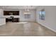 Dining area adjacent to the kitchen, featuring tile flooring, large windows, and a modern light fixture at 2517 N Pony Ln, Casa Grande, AZ 85122