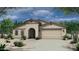 Exterior elevation of a single-story home with a tile roof, desert landscaping, and a two-car garage at 2517 N Pony Ln, Casa Grande, AZ 85122