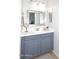 Bathroom vanity with gray cabinets, a white countertop, and a framed mirror at 2725 E Mine Creek Rd # 1187, Phoenix, AZ 85024