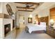 Spacious main bedroom with fireplace, wood ceiling beams, and ensuite bathroom access at 27440 N Alma School Pkwy # 101, Scottsdale, AZ 85262