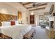 Large main bedroom with fireplace, wooden headboard, and outdoor patio access at 27440 N Alma School Pkwy # 101, Scottsdale, AZ 85262