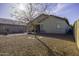 Gravel backyard with patio furniture, a central tree, and surrounding walls at 3018 N Regal Ct, Casa Grande, AZ 85122