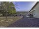 Gravel backyard with patio furniture, a shade tree, and a paved walkway at 3018 N Regal Ct, Casa Grande, AZ 85122
