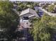 An aerial view of a home with a backyard, patio furniture, and lush trees at 3018 N Regal Ct, Casa Grande, AZ 85122