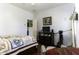 Bedroom with a patterned comforter, wooden furniture, and a cozy sitting area at 3018 N Regal Ct, Casa Grande, AZ 85122