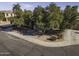 Aerial view of a home's front yard with trees, landscaping, and a driveway at 3018 N Regal Ct, Casa Grande, AZ 85122