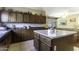 Open kitchen with an island, wood cabinets, and view of the pool table room at 3018 N Regal Ct, Casa Grande, AZ 85122