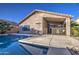 Backyard featuring a refreshing pool, covered patio, and desert landscaping at 3335 E San Angelo Ave, Gilbert, AZ 85234