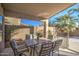 Covered patio with outdoor dining set and fenced backyard at 3335 E San Angelo Ave, Gilbert, AZ 85234