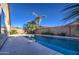Tranquil backyard with a clean pool, palm trees, and a block wall fence at 3335 E San Angelo Ave, Gilbert, AZ 85234
