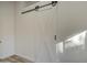 White barn door on black hardware at 3335 E San Angelo Ave, Gilbert, AZ 85234