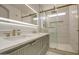Bathroom with marble tile, a glass shower, and brass fixtures at 3335 E San Angelo Ave, Gilbert, AZ 85234