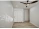 Bedroom with wood-look flooring, large closet, and bright white walls at 3335 E San Angelo Ave, Gilbert, AZ 85234