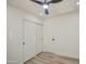 Bright bedroom with sliding closet doors, wood-look flooring, and ceiling fan at 3335 E San Angelo Ave, Gilbert, AZ 85234