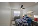 Cozy bedroom featuring a plaid comforter, gray dresser, and playful wall decor at 3335 E San Angelo Ave, Gilbert, AZ 85234